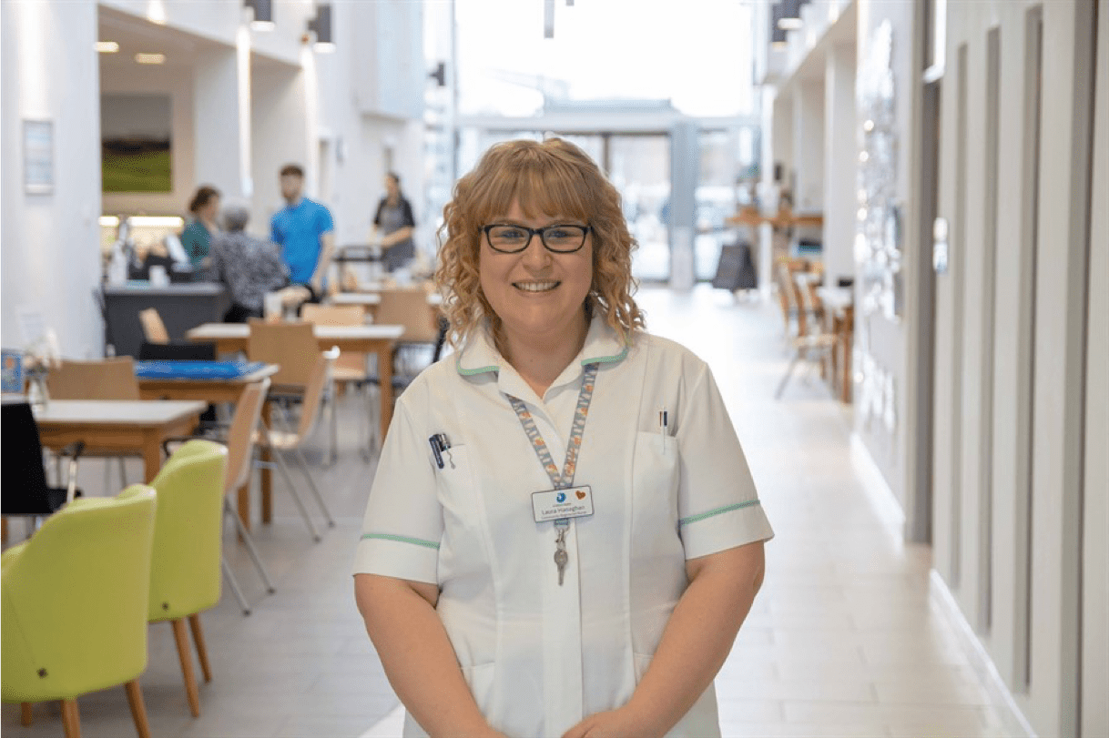 Nurse in the hospice cafe smiling