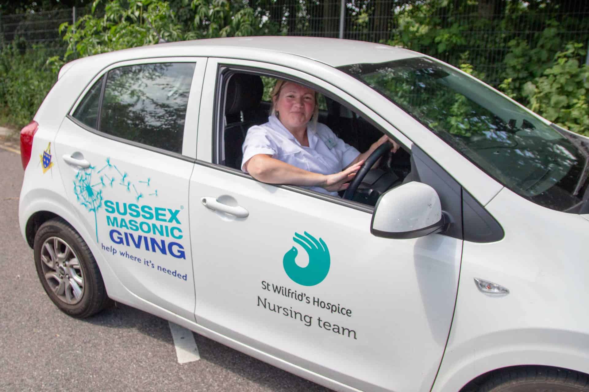 Nurse in community car