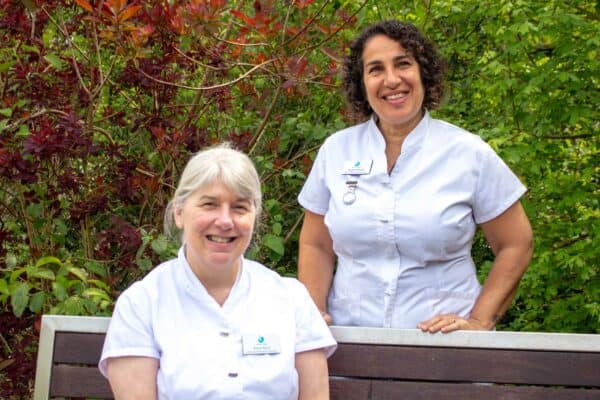 two therapists smiling