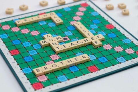 Scrabble board with words on. Friend. Dad. Mum. Aunt. Sister. Teacher. Brother.