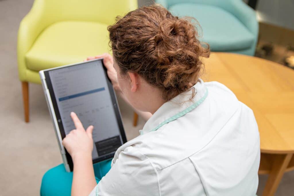Care At Hime Care At Home nurse with tablet