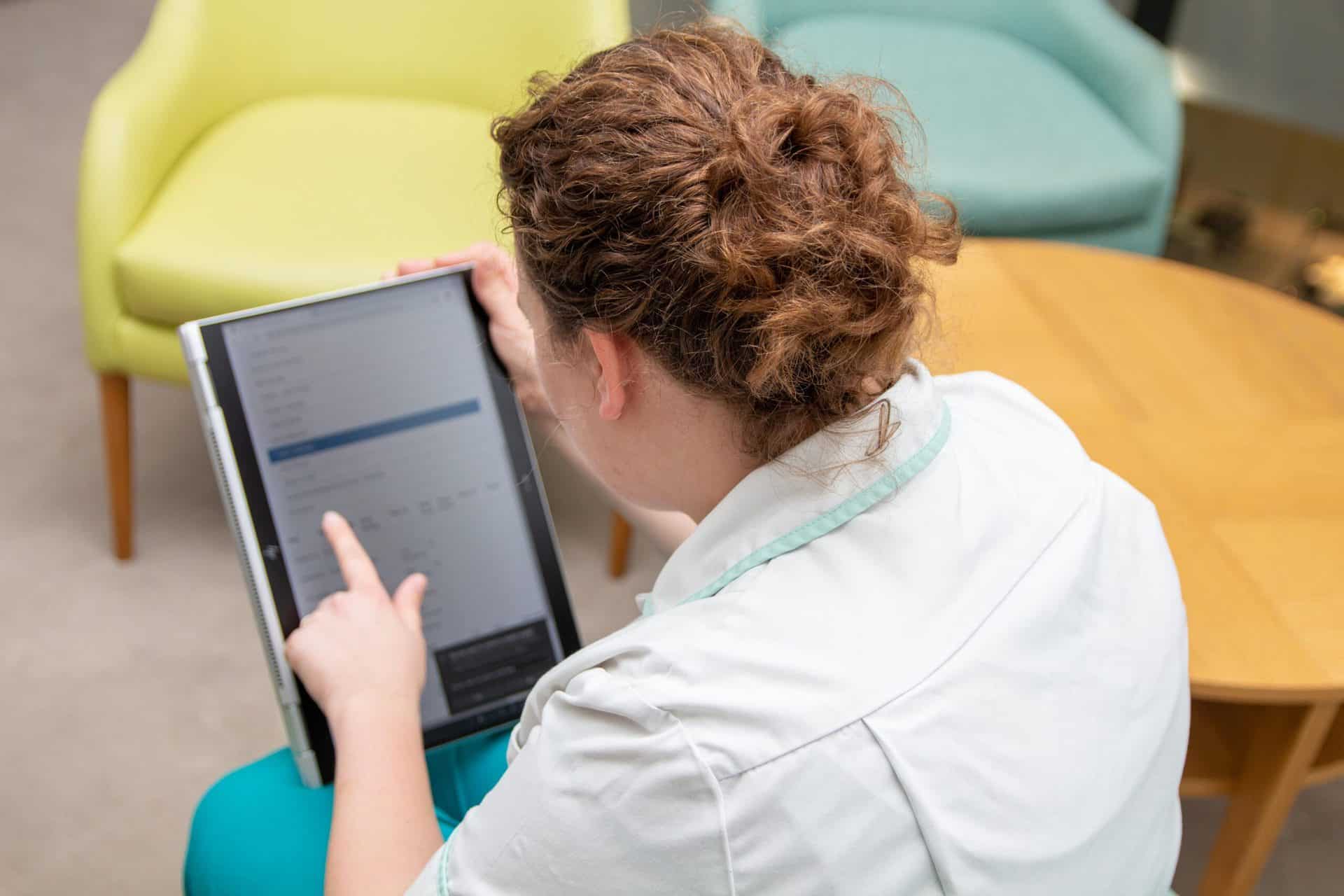 Care At Home nurse with tablet