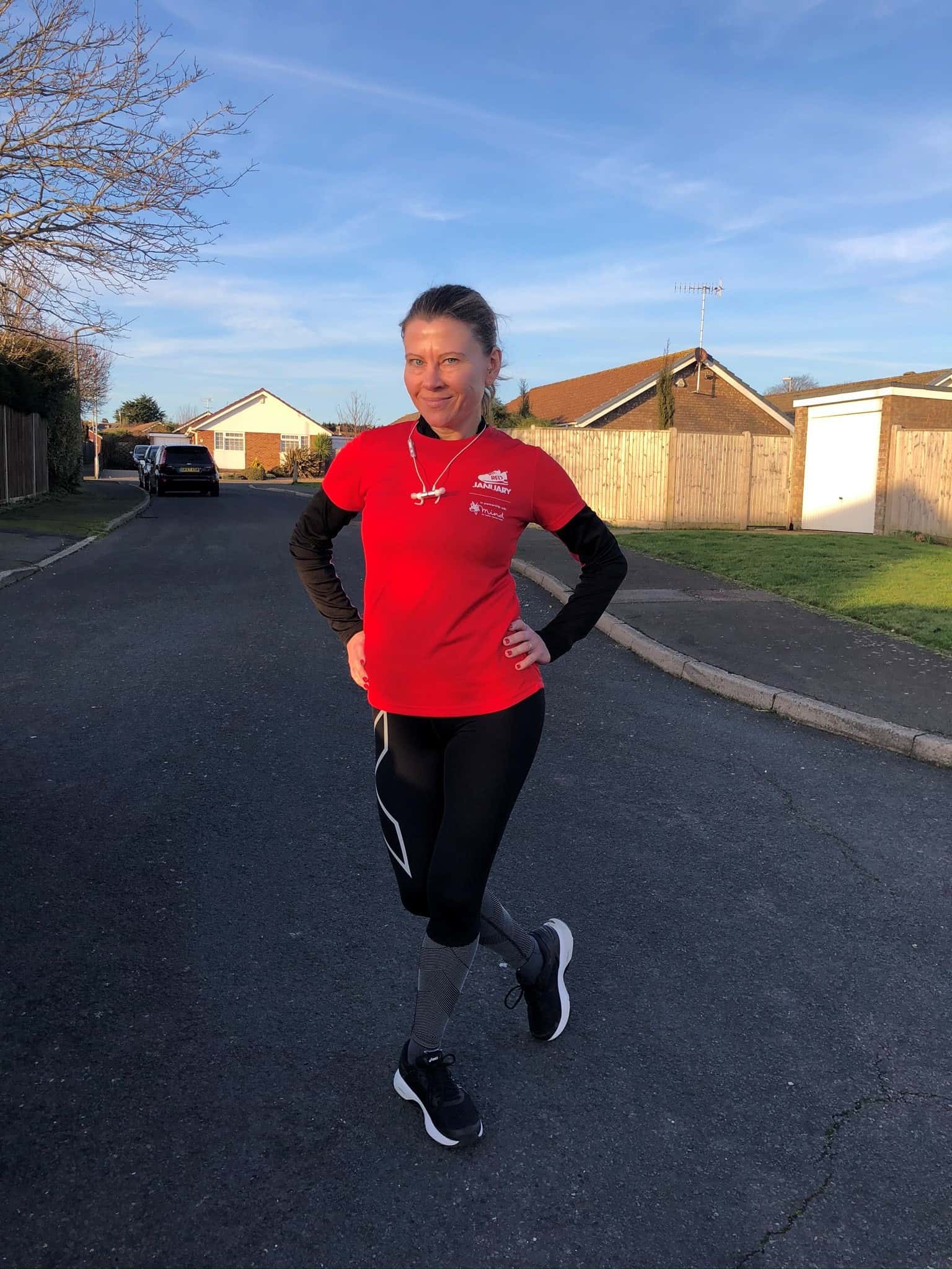 Elaine French in running gear standing on road