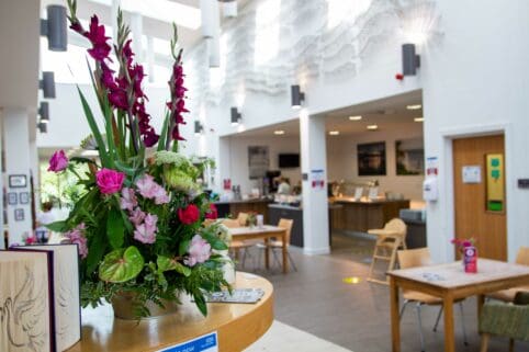 Flowers and display of cakes in hospice cafe