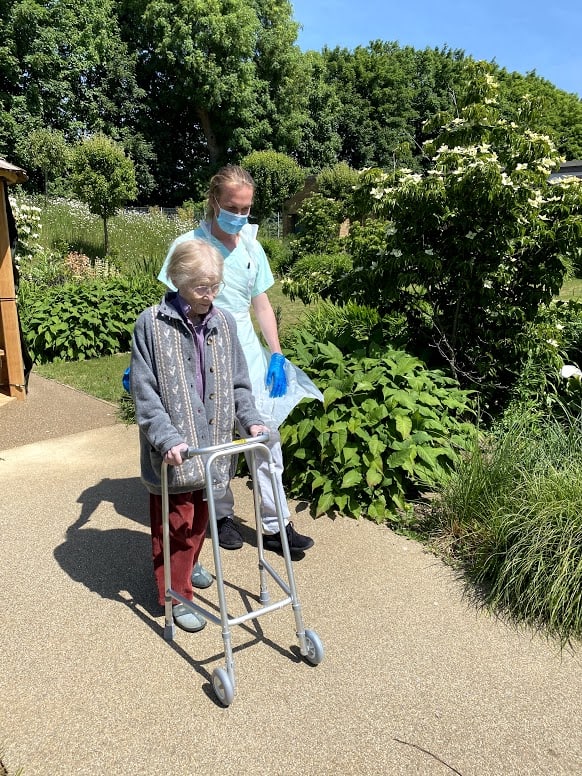 Physio with patient in garden facing camera