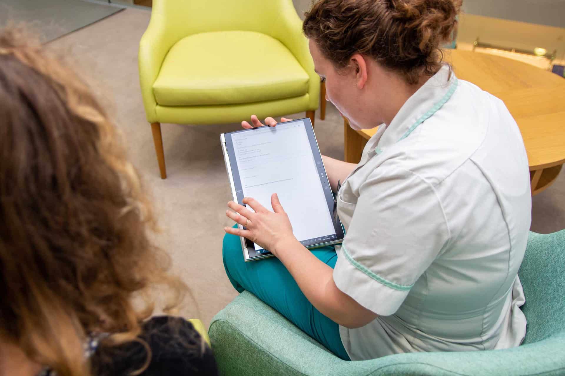 Nurse with patient and tablet device