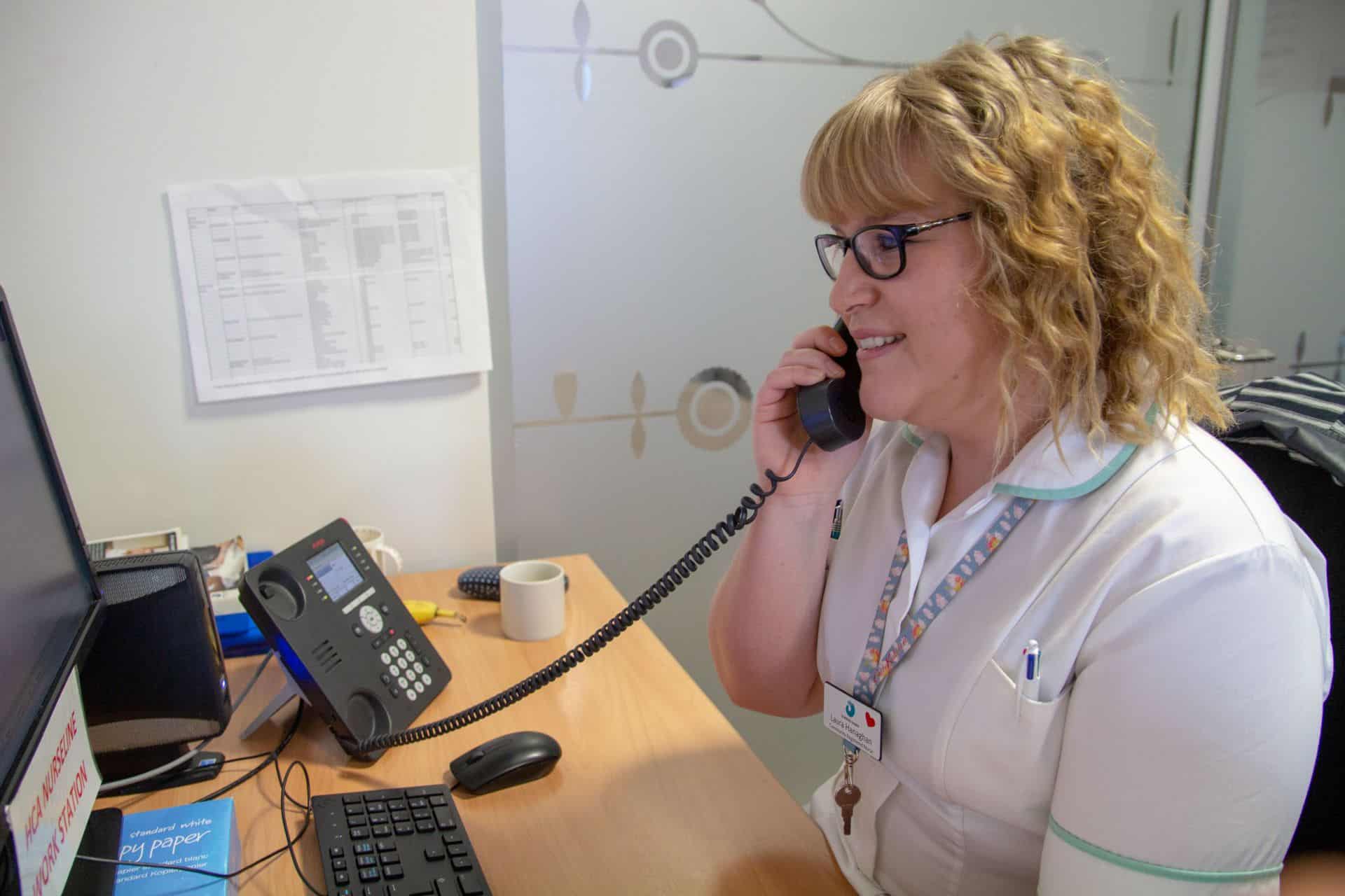 Nurse on telephone smiling