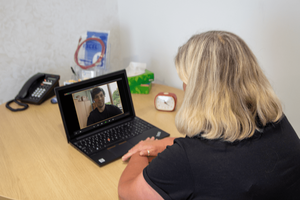 Women and man talking via conference call on Laptop