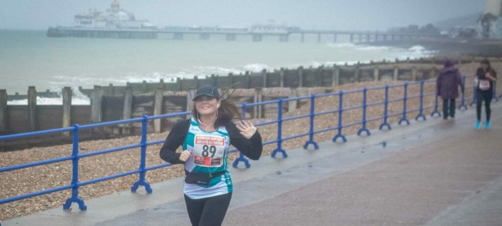 Runner in St Wilfrid's top running along Eastbourne Seafront