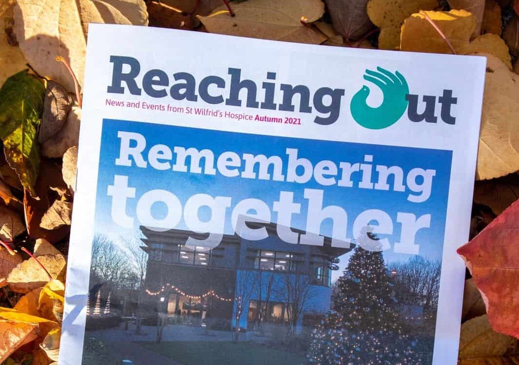 Copies of Reaching Out Magazine on leaf background