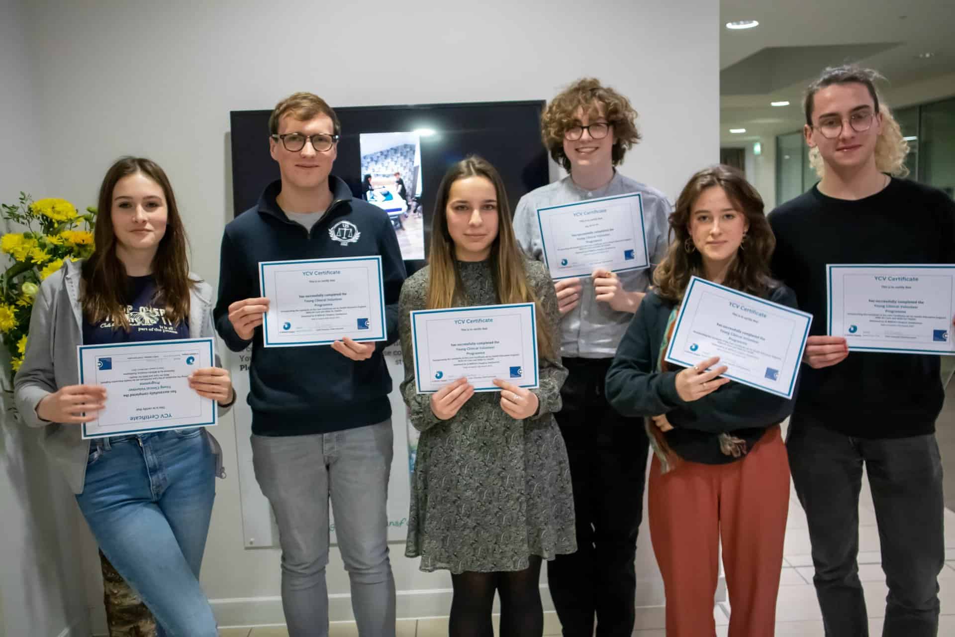 A group of 6 young people holding certificates