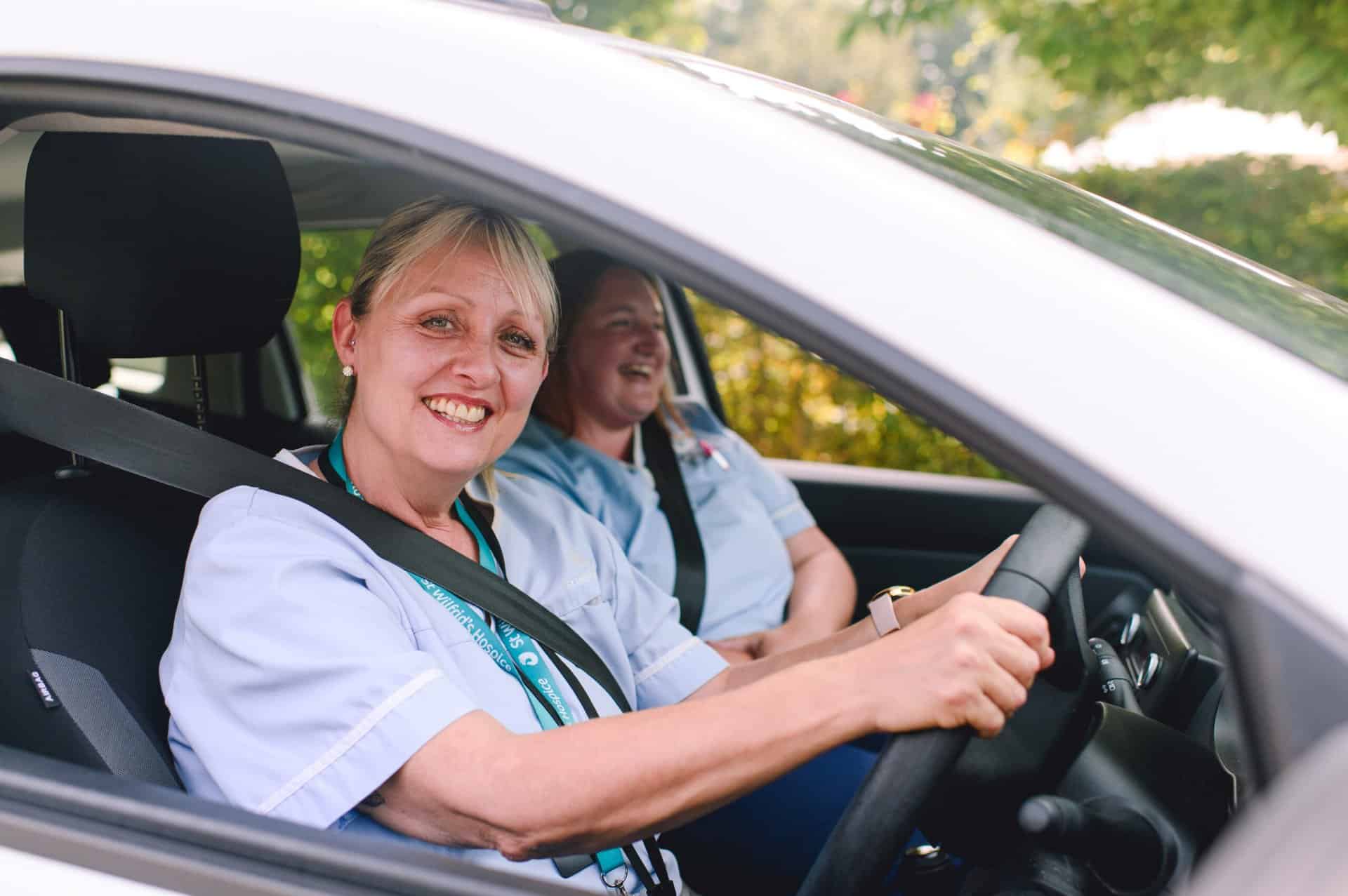 Two women from Community Care Team in car