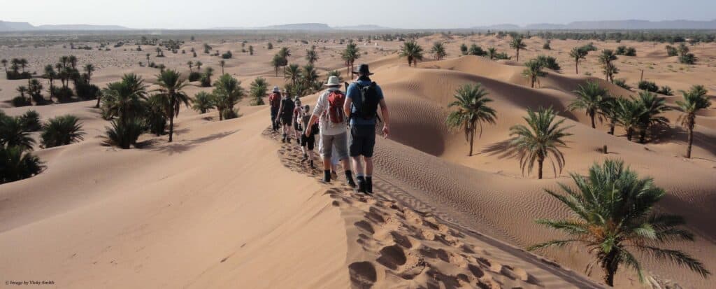 Two people walking through the desert