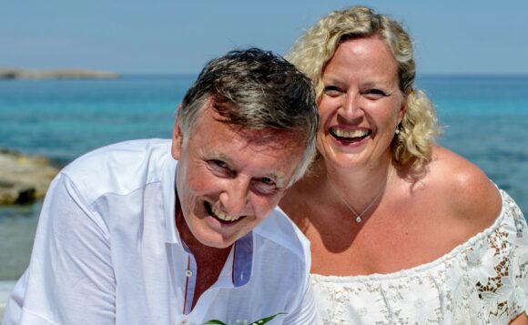 man and woman in white on beach