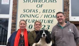 three people and dog